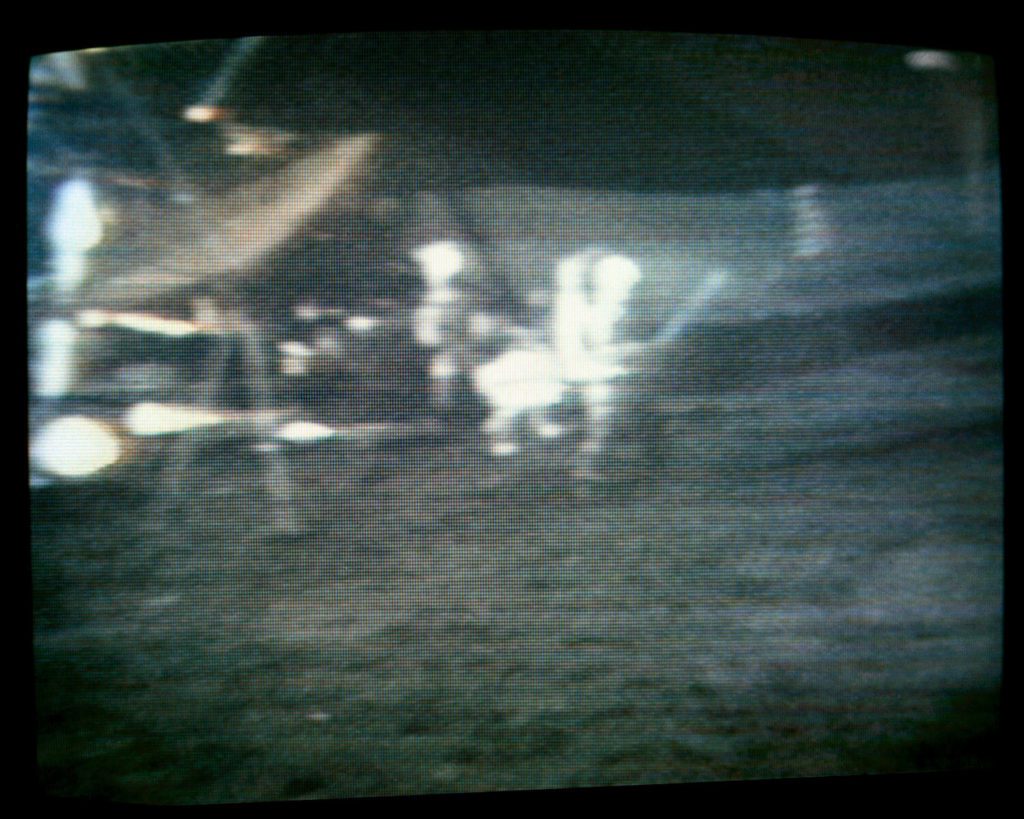 Apollo 14 lunar landing. Television image of Apollo 14 commander Alan B. Shepard (centre) playing golf on the Moon